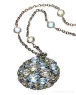 Elevate your style with the A & Furst Bouquet pendant necklace, featuring a stunning cluster of blue topaz, August's birthstone peridot, and an array of diamonds and sapphires and other precious gemstones expertly set to perfection. 🌿💎 Suspended on a graceful 36" chain, this necklace brings a burst of color and light, perfect for layering or wearing solo as a statement piece. Its vibrant hues evoke the freshness of summer, adding a joyful touch to every outfit.⁠
⁠
Experience artisan craftsmanship and timeless luxury jewelry at Oster Jewelers in Denver, CO.⁠
⁠